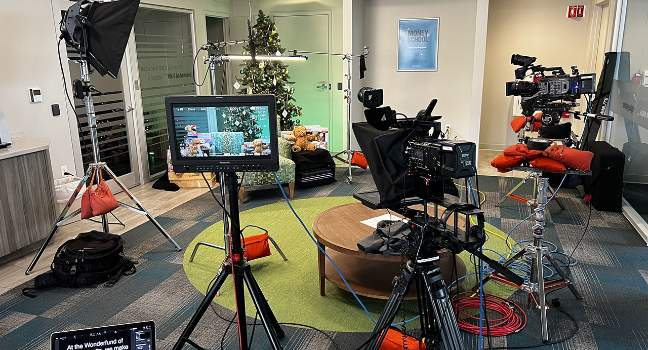 Camera, monitor, lighting, and grip gear on a client production set